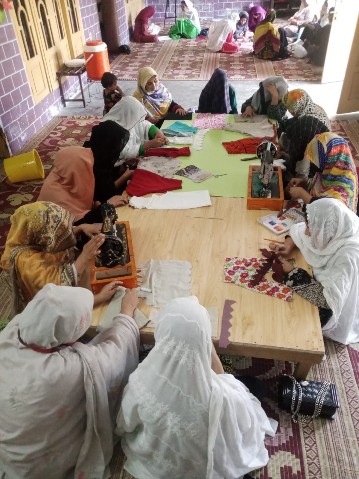 Trainees learning embroidery together in a group session at Da Hunar Stori Vocational Training Centre
